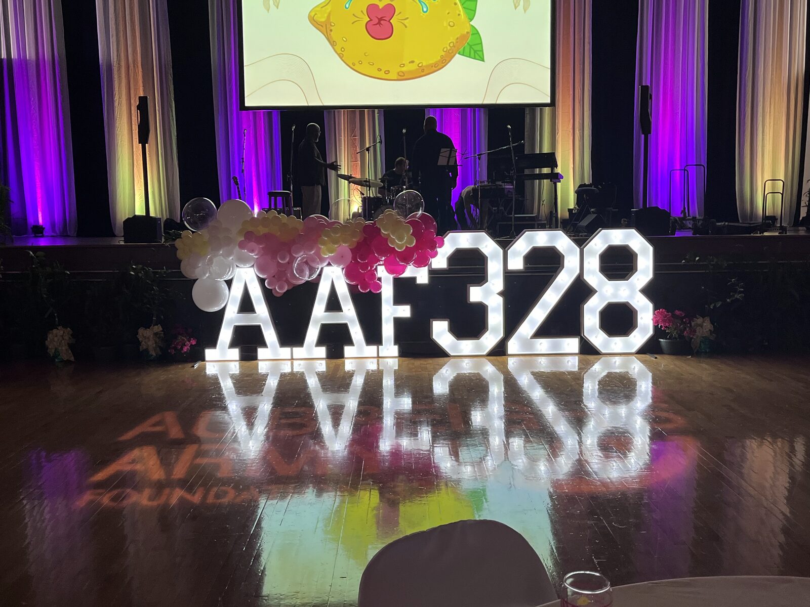 AAF 328 in lit letters on a ballroom dance floor